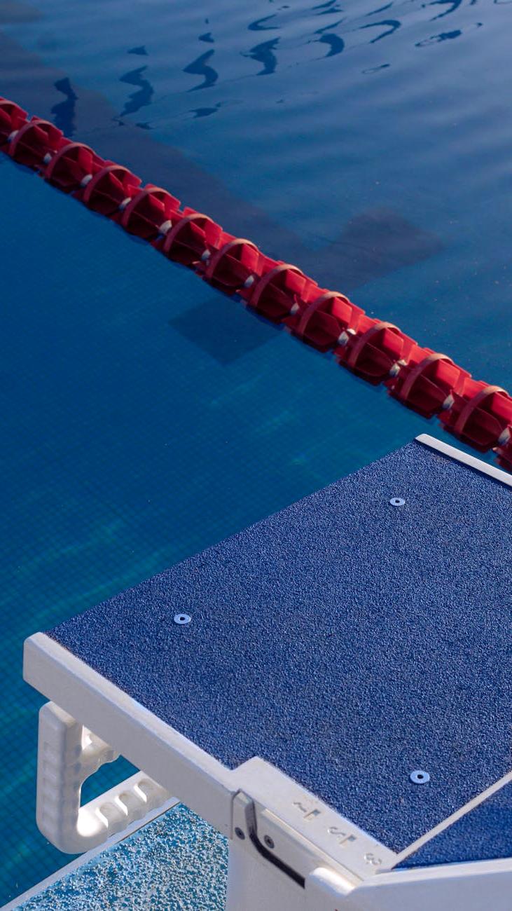 Friendly vigarii pool cleaning team standing by a sparkling clean swimming pool